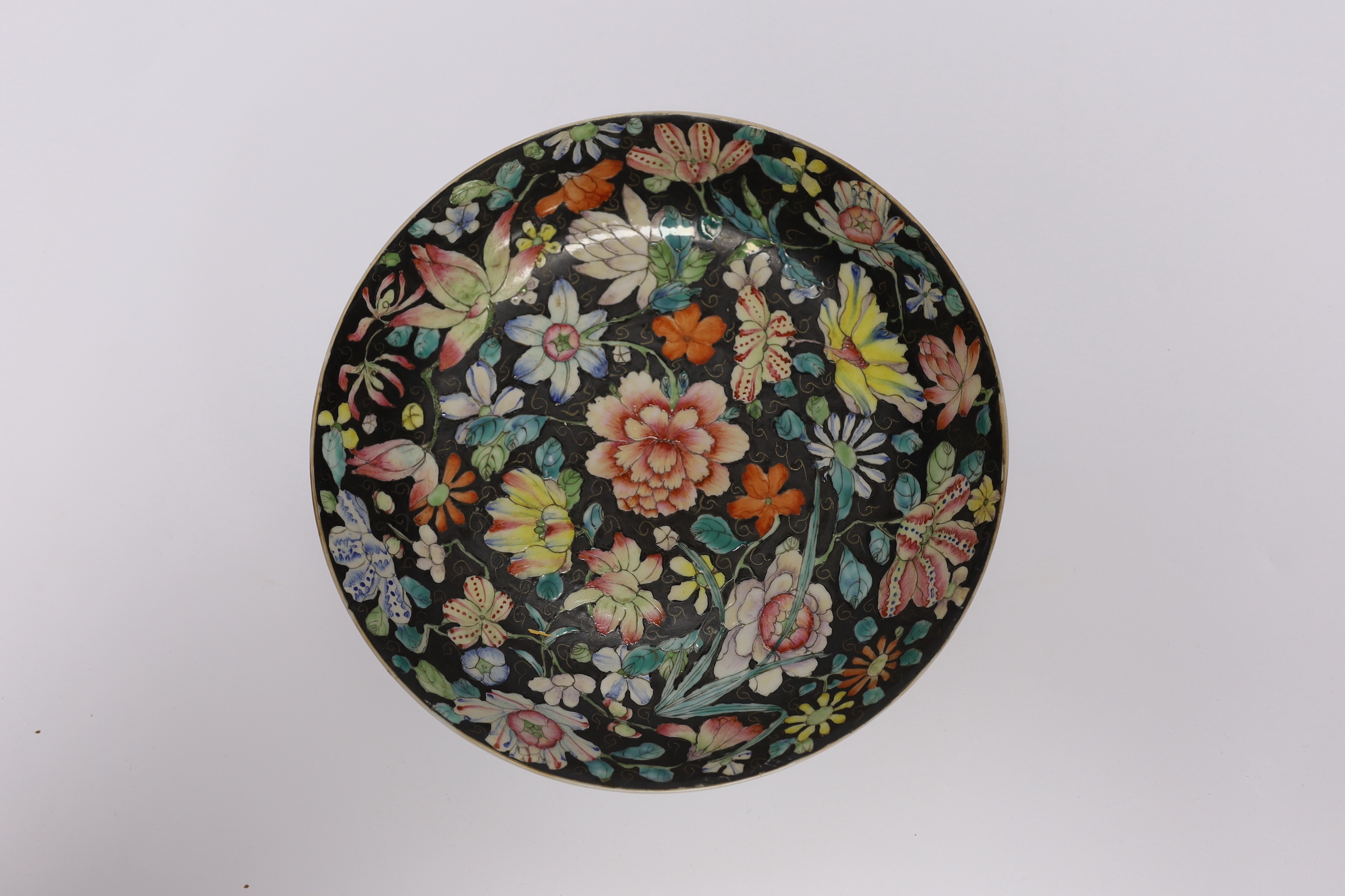 A Chinese famille noire floral dish, Qianlong mark, late 19th/early 20th century and two Chinese enamelled porcelain plates, 19th century, famille noir dish 23.5cm diameter